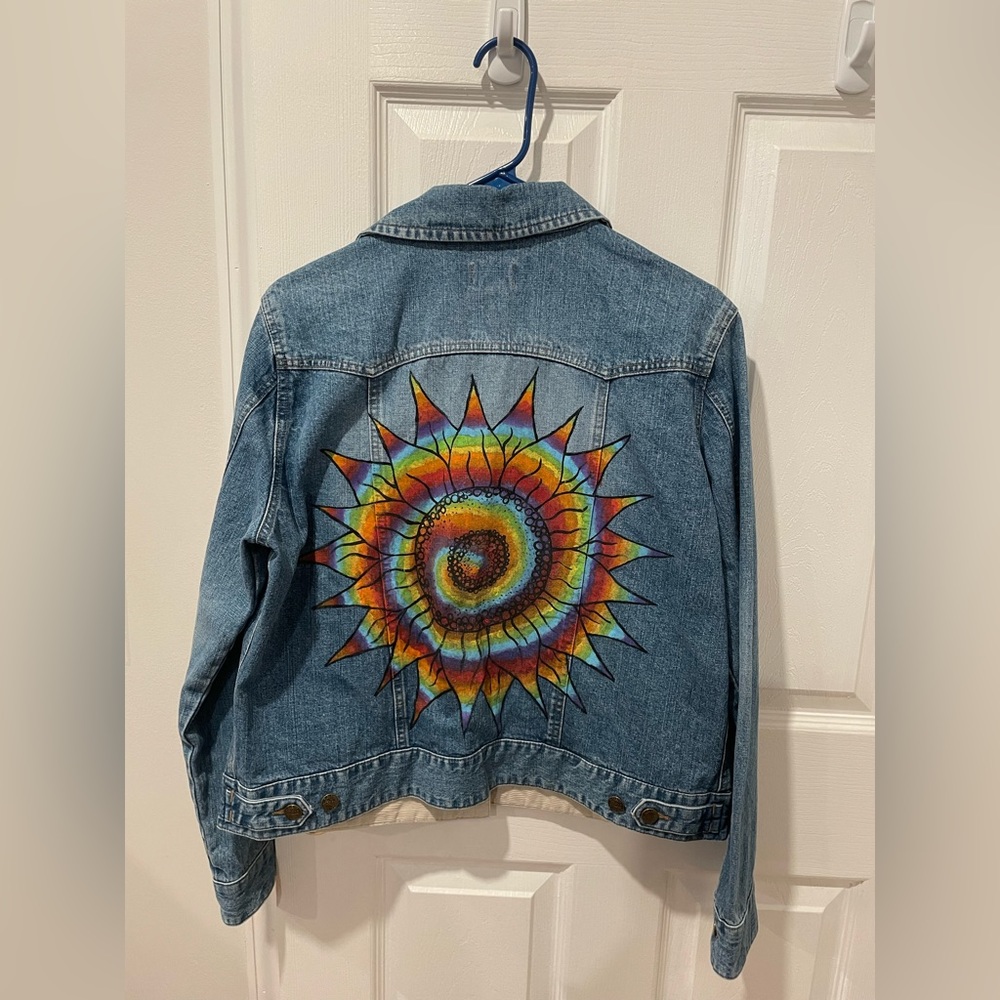 Bass Jean jacket with rainbow sun swirl painted on the back